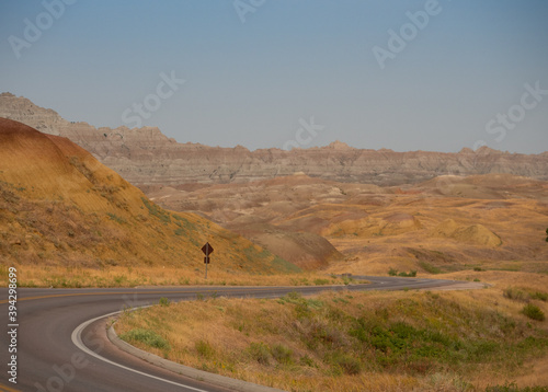 Yellow Hillsides with Highway in Badlands National Park with a highway winding through the photo.