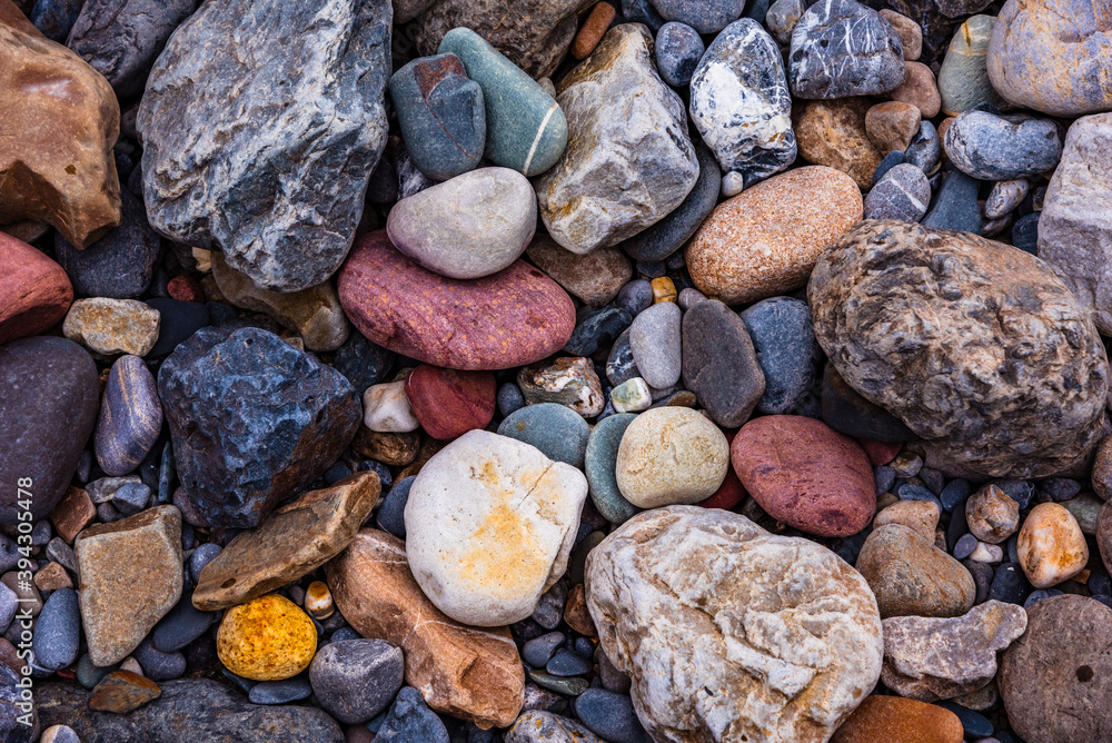 Background wallpaper of colorful stones left bySpiti river near its river bed in Spiti valley of Himachal Pradesh, India. Different rocks colors are the result of the minerals that make up the rocks. Background wallpaper of colorful stones left bySpiti river near its river bed in Spiti valley of Himachal Pradesh, India. Different rocks colors are the result of the minerals that make up the rocks.