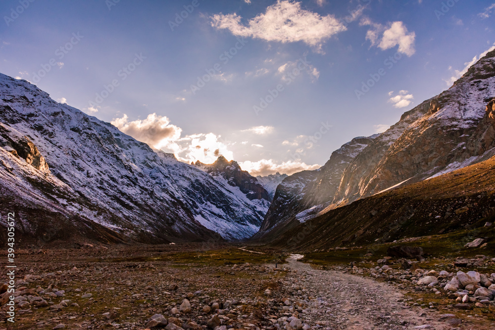 Serene Landscape of Chandra river valley & snow capped mountains during sunset near Rohtang Pass in Lahaul & Spiti district of Himachal Pradesh, India.