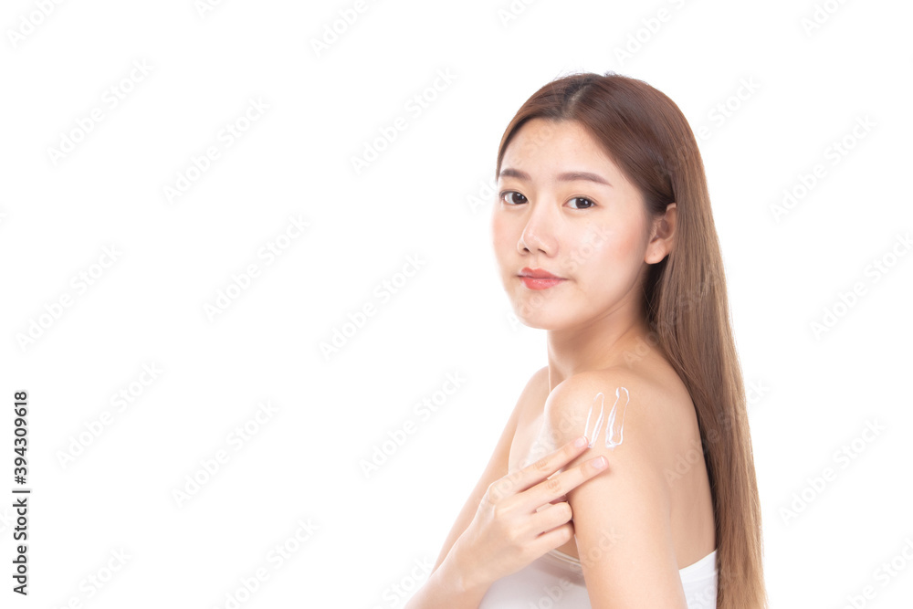 Attractive young Asian woman applying body cream and smiling while standing on white background. Attractive young Asian woman applying body cream and smiling while standing on white background.