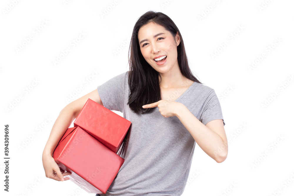 Happy pretty young woman holding gift box present in christmas or new year on white background. Happy pretty young woman holding gift box present in christmas or new year on white background.