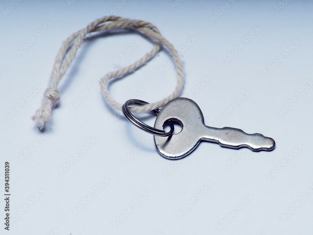 Close up shoot of silver little key on a white background