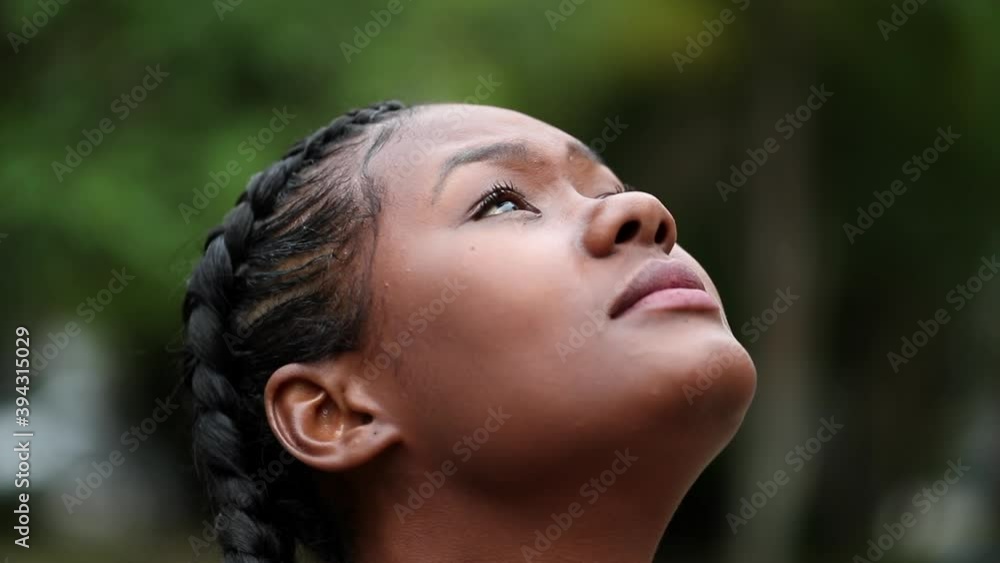Contemplative black African girl face looking at sky Contemplative black African girl face looking at sky