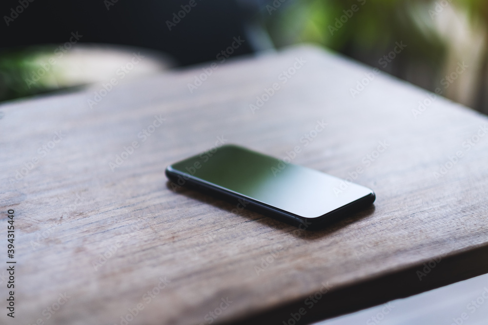 A mobile phone on wooden table