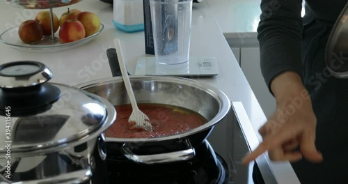 hands of a woman cooking tomato sauce called SUGO