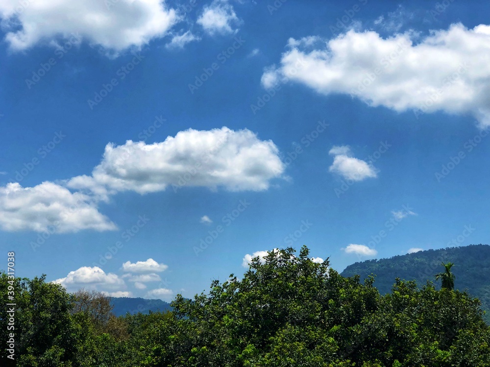 blue sky and clouds over the hills