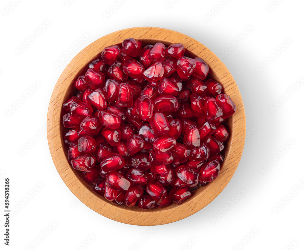 Pomegranate seeds in a separate wooden bowl on a white background, top view Pomegranate seeds in a separate wooden bowl on a white background, top view