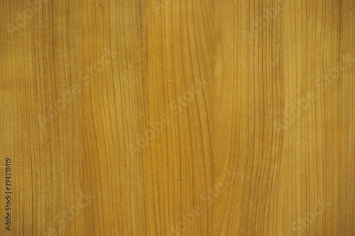 Wooden wall with texture and grain in dark warm brown and golden tone for background and decoration