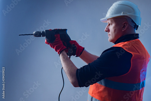 Builder with a drill in his...