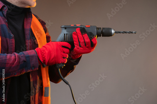 A man with a drill in his h...