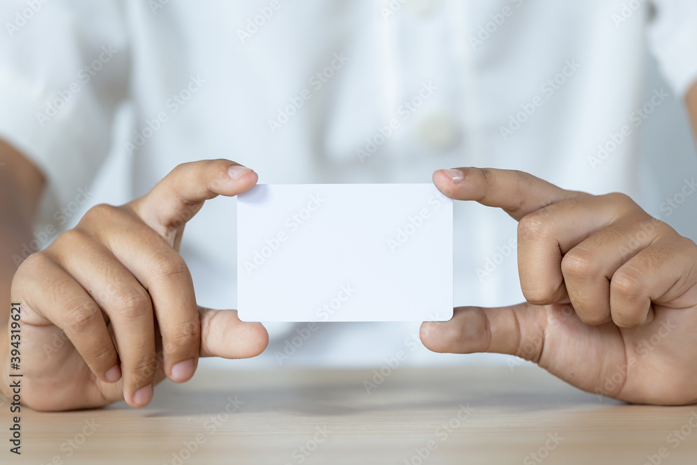 Hand holding the empty white card Hand holding the empty white card