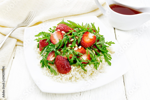 Salad of strawberry and couscous on wooden board