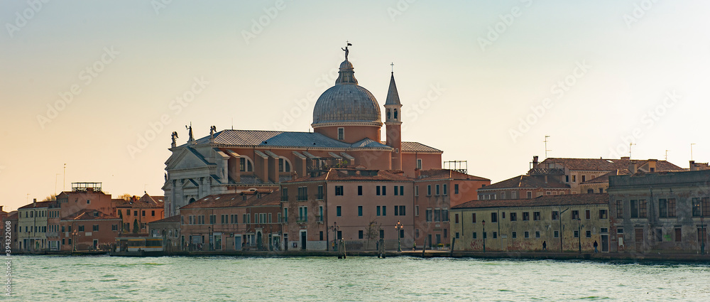 Water channels of Venice city. Church of the Santissimo Redentore and Galleria Il Redentore buildings are on Grand Canal in Venice, Italy.