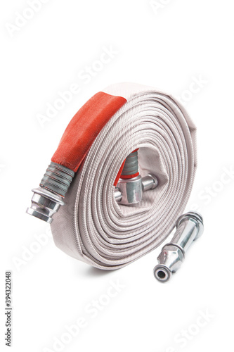 Red fire hose coil isolated on the white background.