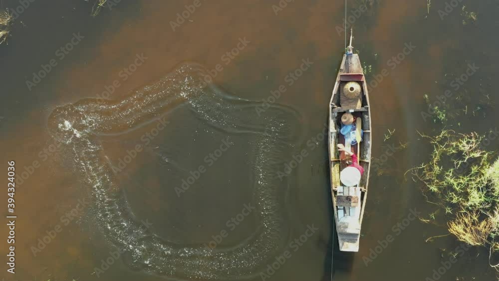 Aerial view from drone. Asian fishermen use traditional fishing nets in the lake in the morning. Aerial view from drone. Asian fishermen use traditional fishing nets in the lake in the morning.