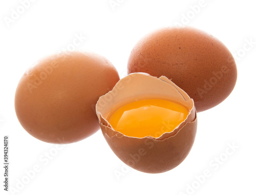 brown eggs with one broken egg isolated on white.