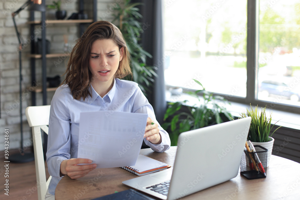 Happy entrepreneur woman sit at desk reading good news in post paper correspondence. Happy entrepreneur woman sit at desk reading good news in post paper correspondence.