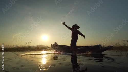 Slow motion of asian fishermen use traditional fishing nets in the lake