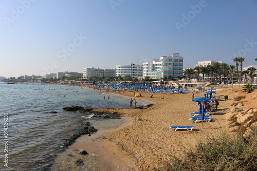 relax on the beach under blue umbrellas in Cyprus Protaras photo