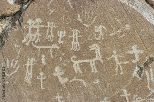 Humans, hands and animals carving on rock: detail of antique silk road era petroglyphs above Langar village in the Wakhan Corridor in the Gorno-Badakshan Pamir region of Tajikistan