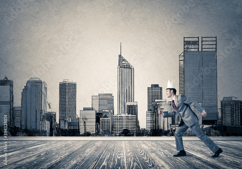 King businessman in elegant suit running and drawn cityscape silhouette at background