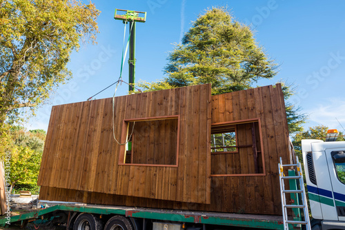Canvas-taulu truck transporting parts of a wooden house