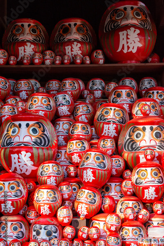 Daruma  round traditional Japanese dolls decorated in the garden of Katsuou-ji temple in Minoh  Osaka  Japan.  Notes  Japanese character on daruma means  happiness  or  Win .