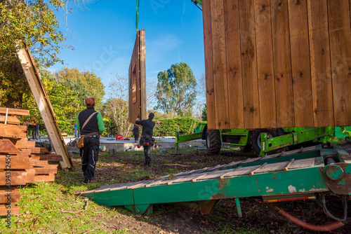 Canvas-taulu truck transporting parts of a wooden house