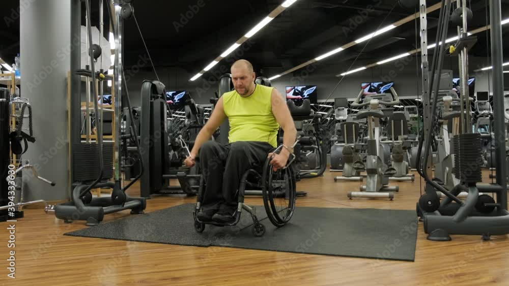 Disabled man training in the gym of rehabilitation center Disabled man training in the gym of rehabilitation center