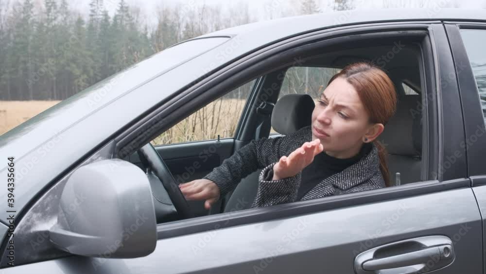 Young woman in traffic jam, nervous girl in automobile. Road collapse or traffic accident Young woman in traffic jam, nervous girl in automobile. Road collapse or traffic accident
