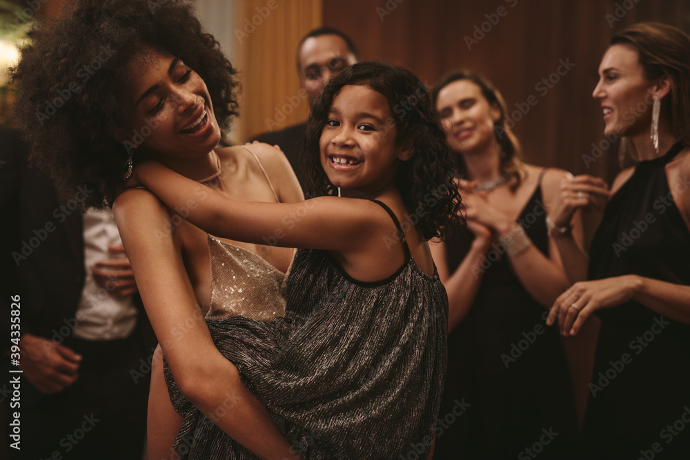 Mother enjoying dancing with her daughter at party Mother enjoying dancing with her daughter at party