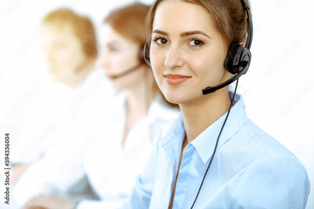 Call center. Focus on beautiful business woman in headset Call center. Focus on beautiful business woman in headset