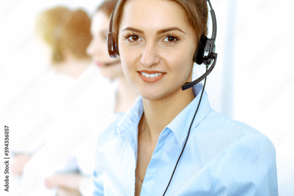 Call center. Focus on beautiful business woman in headset Call center. Focus on beautiful business woman in headset