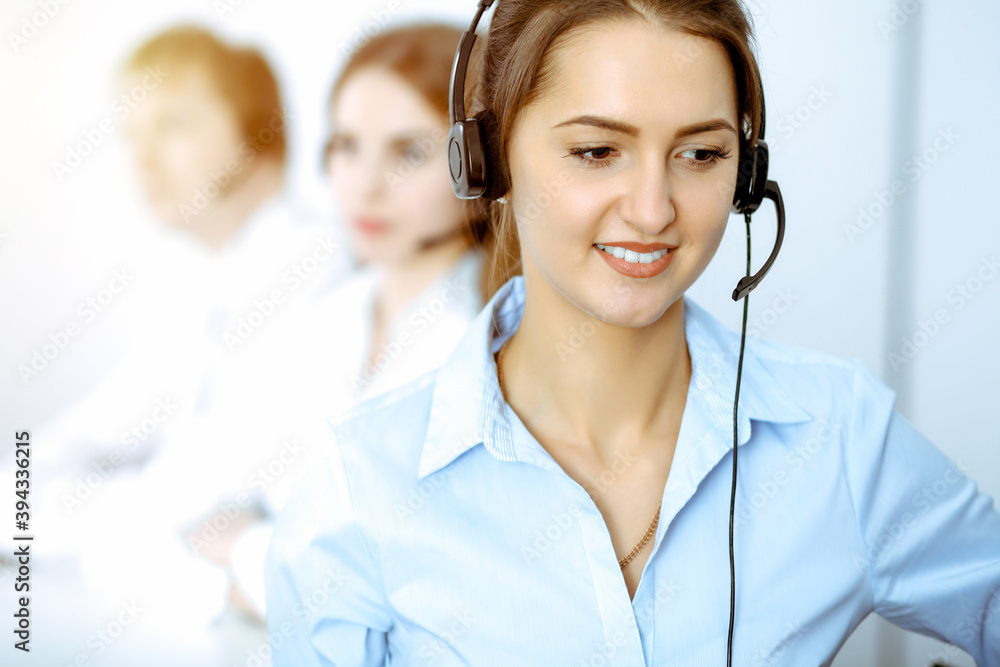 Call center. Focus on beautiful business woman in headset Call center. Focus on beautiful business woman in headset