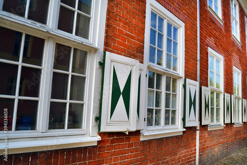 Windows with shutters in an old brick building in Dutch Quarter (Hollandisches Viertel) in Potsdam, Germany, Europe.