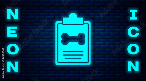 Glowing neon Clipboard with medical clinical record pet icon isolated on brick wall background. Health insurance form. Medical check marks report. Vector.
