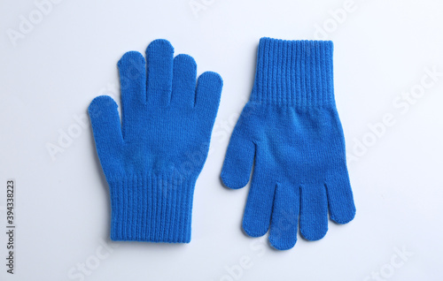 Pair of stylish woolen gloves on white background, flat lay