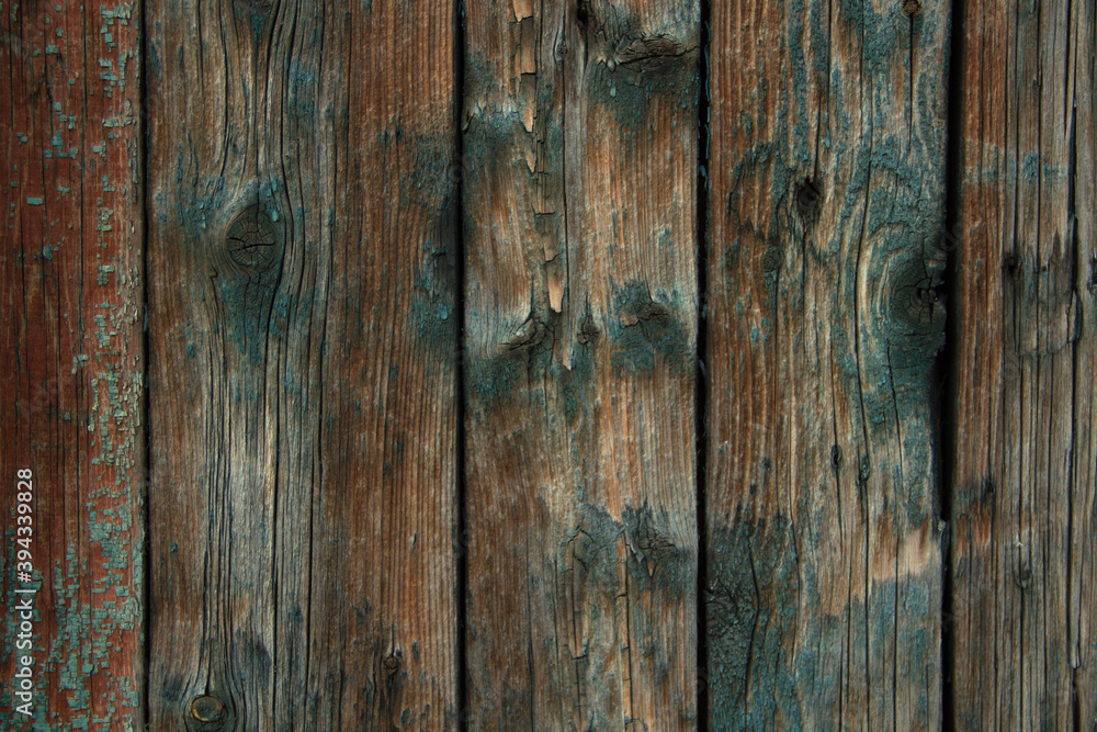 Dark old wooden surface made of separate wooden boards with the remains of paint. Can be used as background with natural texture Dark old wooden surface made of separate wooden boards with the remains of paint. Can be used as background with natural texture