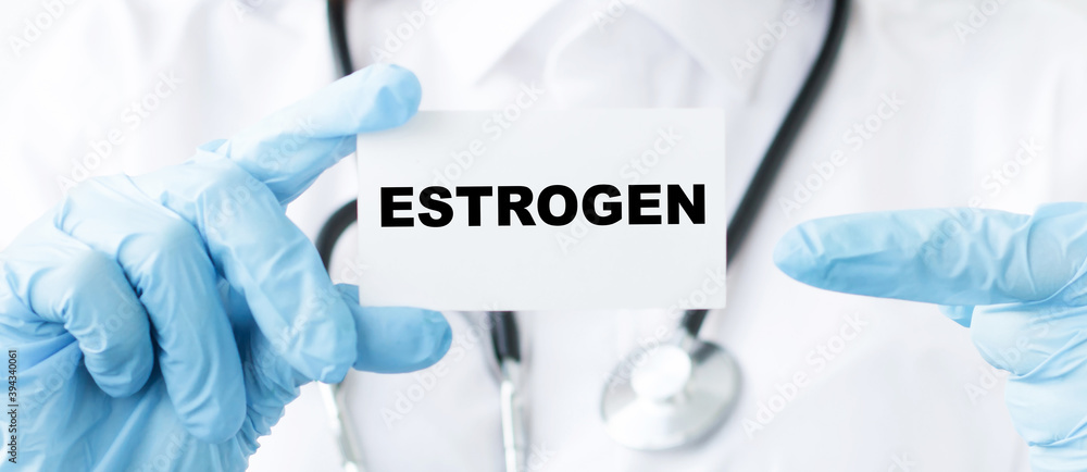 in the hands of a doctor a card with the text estrogen, close-up. Medical concept. in the hands of a doctor a card with the text estrogen, close-up. Medical concept.