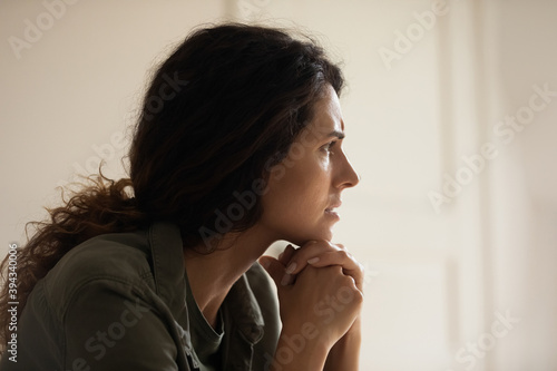 Pensive young caucasian woman look in distance thinking pondering of life relations problems. Upset lonely female loner outcast lost in thoughts, missing or mourning, feel stressed anxious worried.