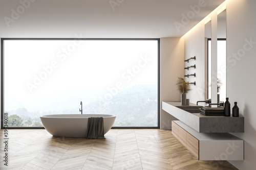Modern white bathroom interior with sink and tub