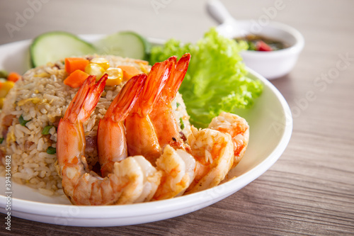 chinese fried rice with barbecue prawn on wooden table