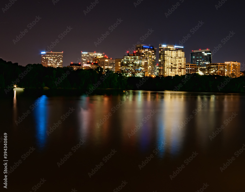 Rossyln, Arlington, Virginia, USA downtown city skyline at night on the Potomac River.