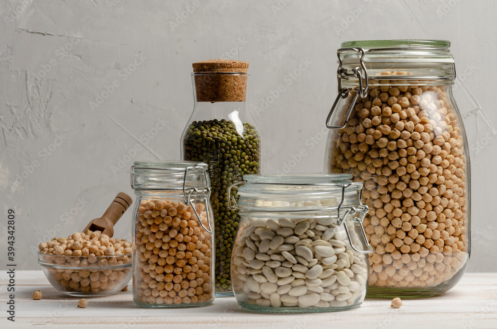 Jar with beans and legumes on gray background with space Jar with beans and legumes on gray background with space