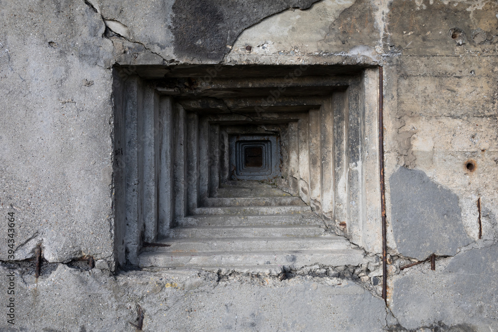 Detail of military bunker and pillbox from world war two - steppen embrasure and hole for gun in the grey wall made of concrete. Detail of military bunker and pillbox from world war two - steppen embrasure and hole for gun in the grey wall made of concrete.