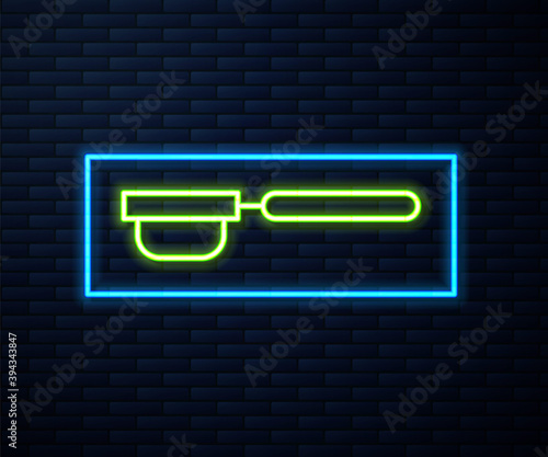 Glowing neon line Coffee filter holder icon isolated on brick wall background. Vector Illustration.