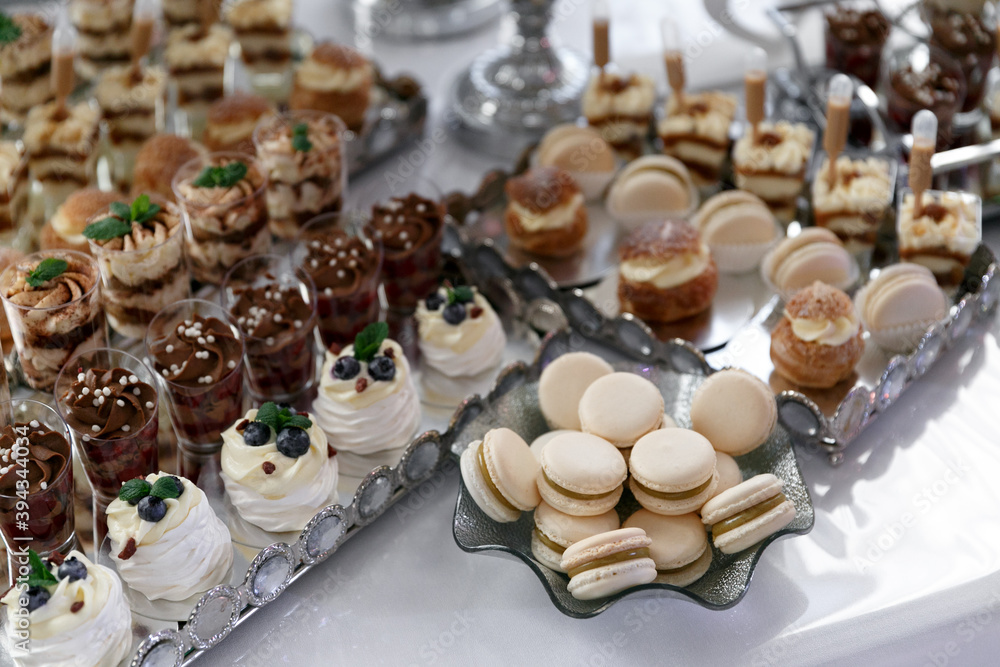 A table with desserts for guests at a wedding. Candy bar