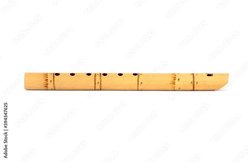 Peruvian flute isolated on white with shadow. South American national musical instrument. A folk musical instrument of the Indians. Peruvian flute isolated on white with shadow. South American national musical instrument. A folk musical instrument of the Indians.