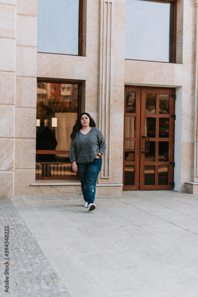 Portrait of a young adult girl on the background of a modern building Portrait of a young adult girl on the background of a modern building