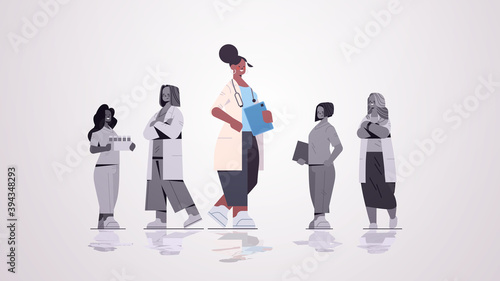 female doctor leader standing in front of medical professionals team in uniform medicine healthcare concept horizontal full length vector illustration